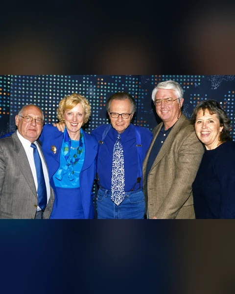 Larry King with Andrea Sims and event guests Larry King centered in blue with Andrea Sims and three guests at an event